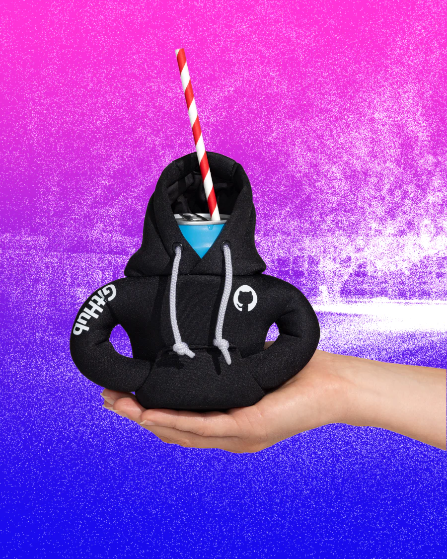 Hand holding a Hoodie Can Coozie with a drink can inside.